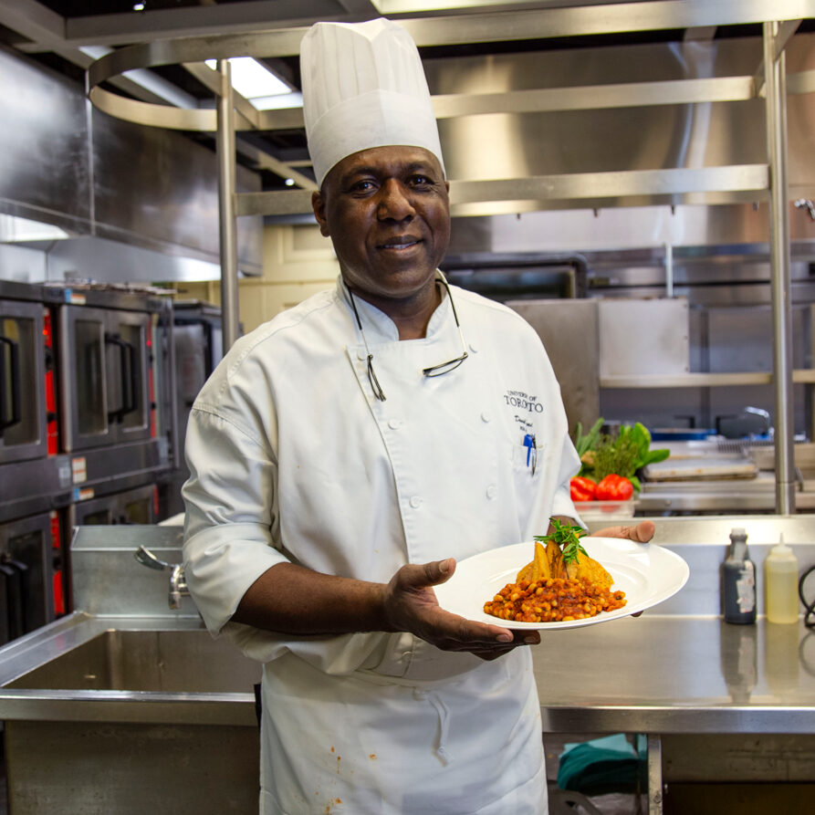 Chef Daniel Ofori holding his dish of Red Red