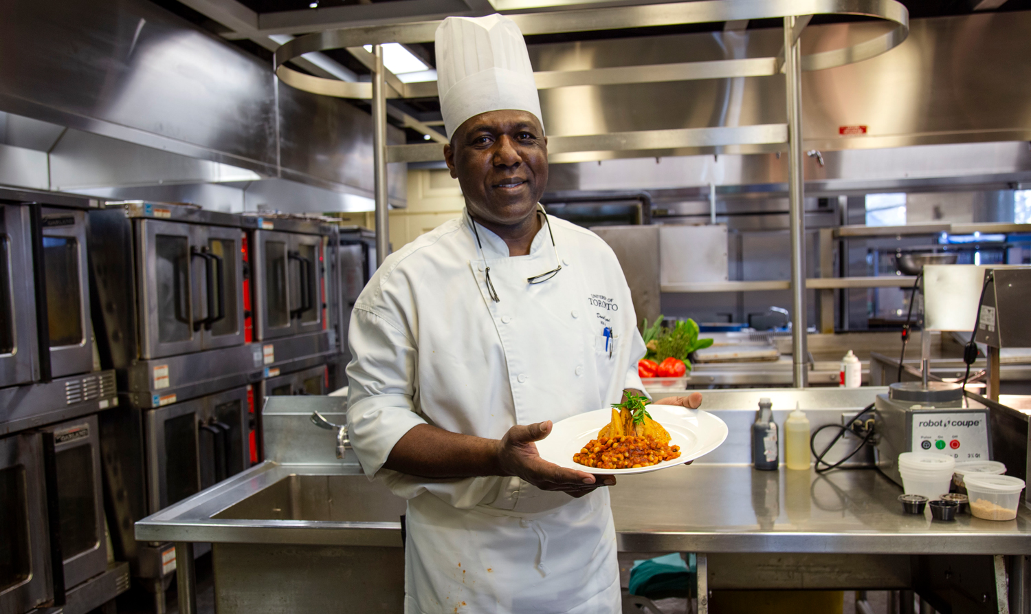 Chef Daniel Ofori holding his dish of Ghana Red Red