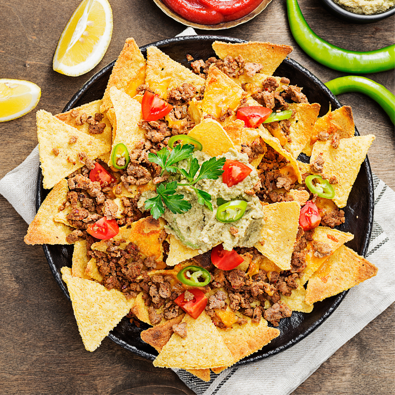 Plate of nachos with various topings