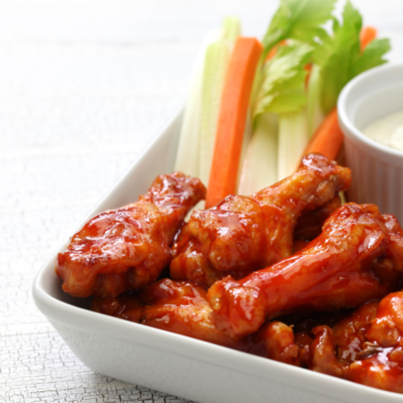 Barbeque chicken wings with sauce and veggies